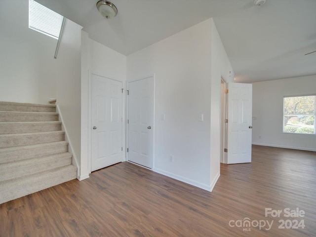 unfurnished room featuring dark wood-type flooring