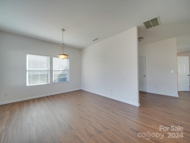 unfurnished room featuring dark wood-type flooring