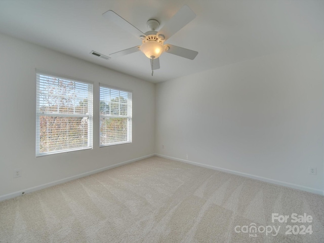 empty room with light carpet and ceiling fan