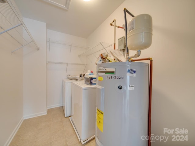 laundry area featuring water heater and washing machine and clothes dryer