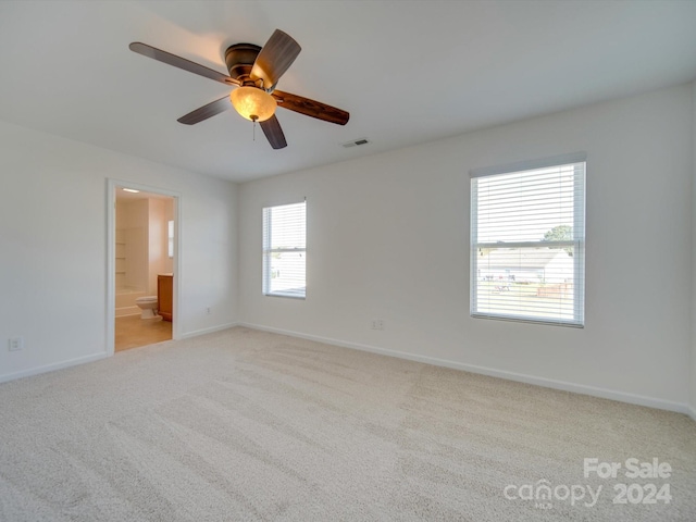 carpeted spare room with ceiling fan