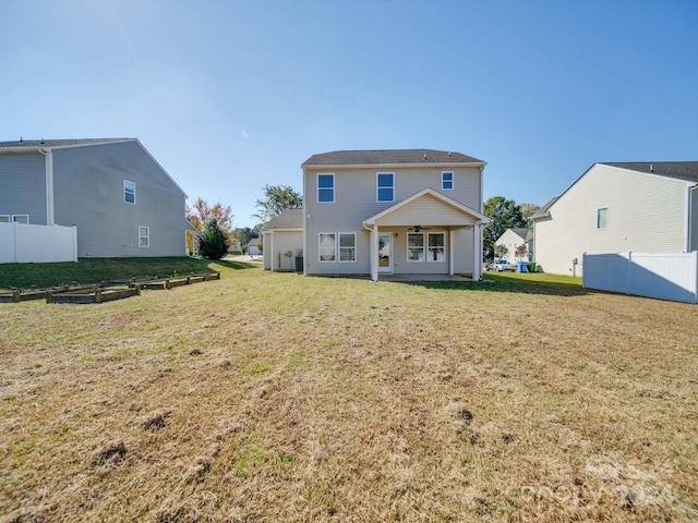 back of property featuring a yard