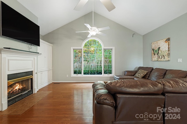 living room with ceiling fan, wood-type flooring, and lofted ceiling