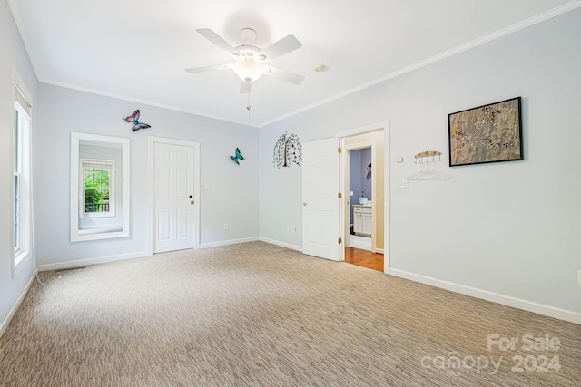 carpeted empty room featuring crown molding and ceiling fan