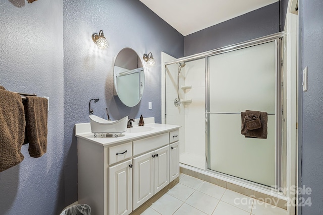 bathroom with vanity, a shower with shower door, and tile patterned flooring