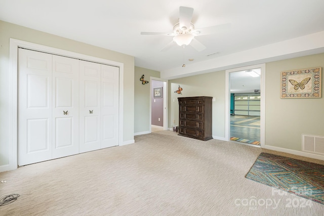 unfurnished bedroom featuring carpet flooring, a closet, and ceiling fan