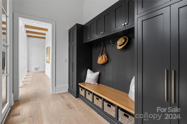 mudroom with light hardwood / wood-style flooring and beam ceiling