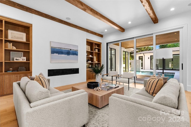 living room with beam ceiling and light hardwood / wood-style flooring