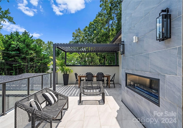 view of patio / terrace with a pergola and a fireplace