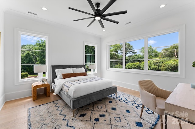 bedroom with ceiling fan, ornamental molding, and light hardwood / wood-style floors