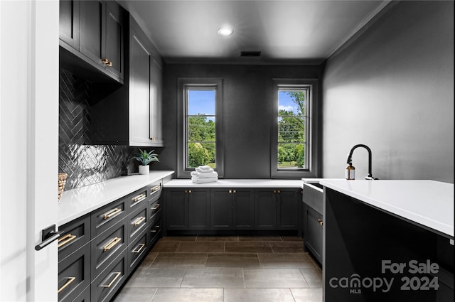 kitchen featuring backsplash and ornamental molding