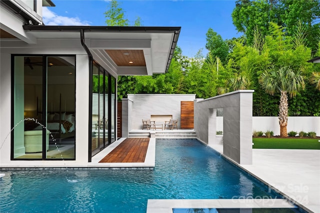 view of pool featuring pool water feature and a patio area