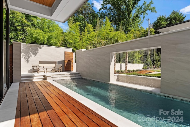 view of swimming pool featuring a wooden deck