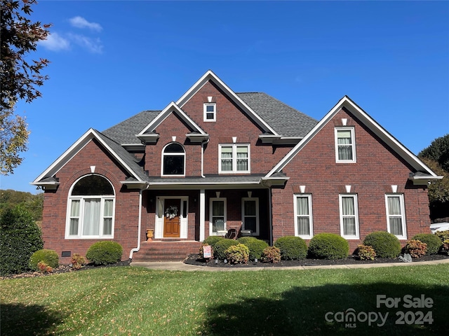 view of front facade with covered porch and a front yard