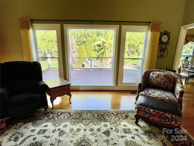 sitting room with a healthy amount of sunlight and wood finished floors