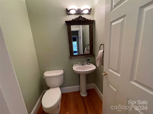 bathroom featuring toilet and hardwood / wood-style flooring