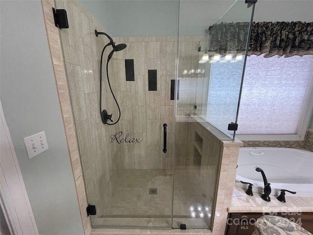 bathroom with a stall shower and a bath