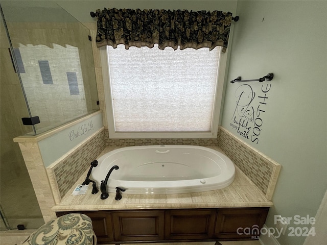 full bathroom featuring a tile shower and a garden tub