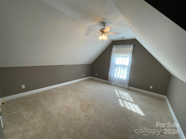 bonus room featuring visible vents, lofted ceiling, baseboards, ceiling fan, and light colored carpet