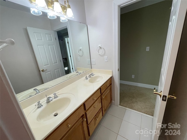 full bath with a sink, tile patterned flooring, and double vanity