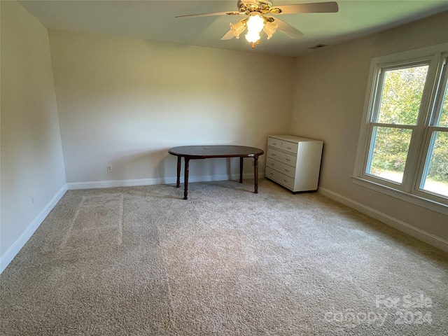 unfurnished room featuring light carpet and ceiling fan