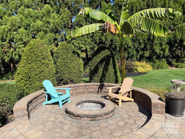 view of patio / terrace featuring an outdoor fire pit