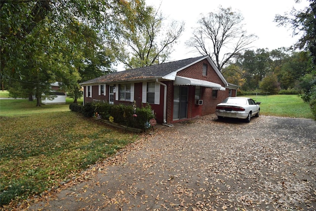 view of side of home featuring a lawn