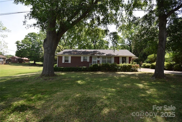 ranch-style house featuring brick siding and a front lawn