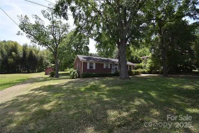 view of yard with an outbuilding and a storage shed