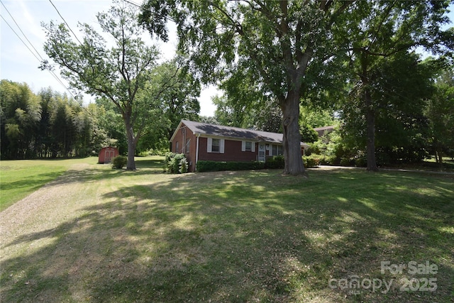 view of yard with an outdoor structure and a storage unit