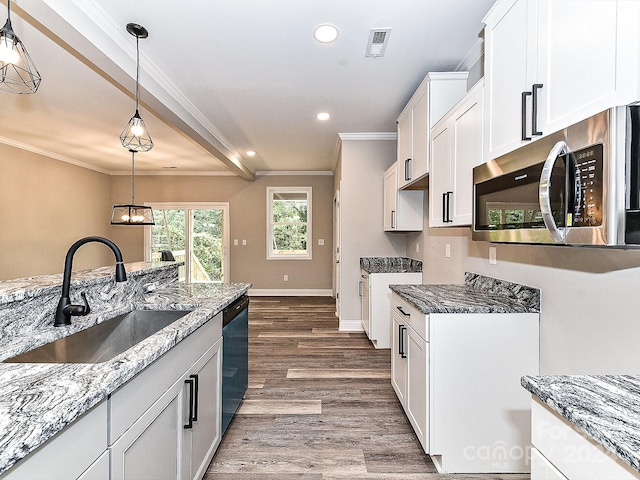 kitchen with dark hardwood / wood-style flooring, ornamental molding, sink, pendant lighting, and white cabinets