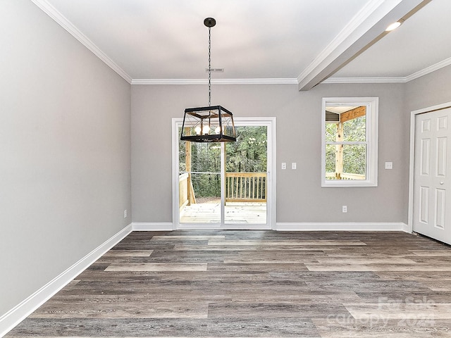 unfurnished dining area with dark hardwood / wood-style flooring, an inviting chandelier, and crown molding