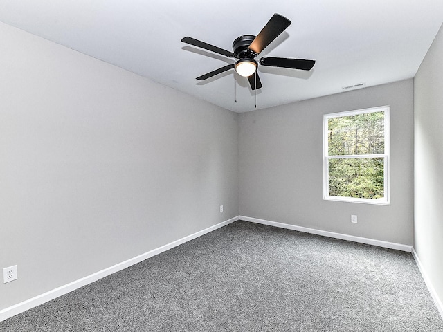 carpeted spare room featuring ceiling fan