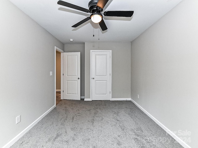 unfurnished bedroom with ceiling fan and carpet floors