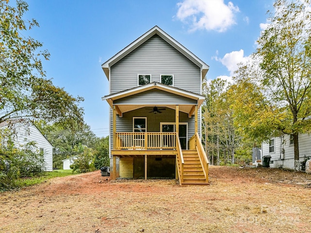 rear view of house featuring ceiling fan and covered porch