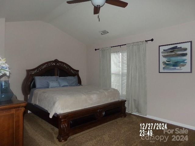 bedroom with carpet floors, ceiling fan, and lofted ceiling