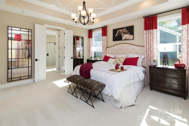 bedroom featuring an inviting chandelier, multiple windows, light colored carpet, and a tray ceiling