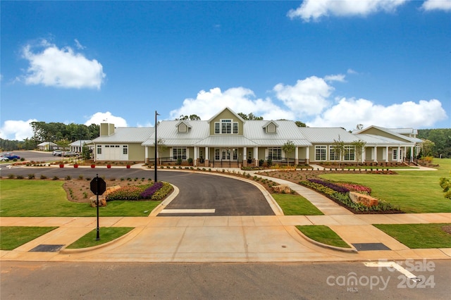 view of front of home with a porch and a front lawn