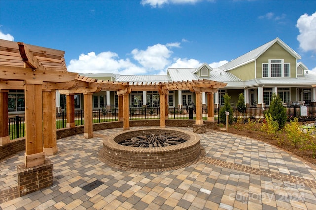 view of patio / terrace with a fire pit and a pergola