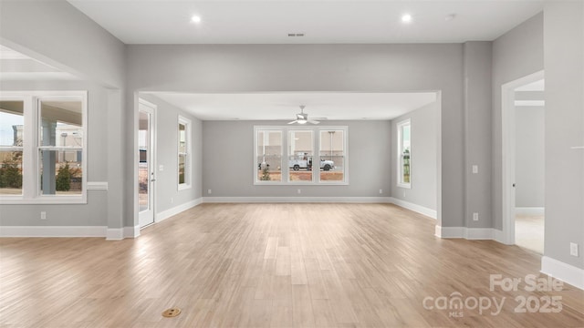 unfurnished living room with ceiling fan, recessed lighting, light wood-style flooring, and baseboards