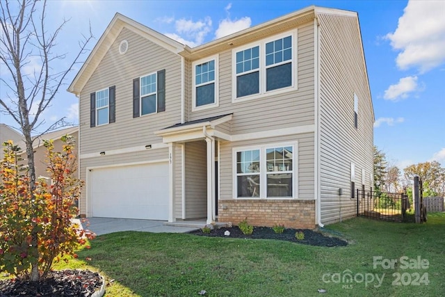 view of front of property with a garage and a front lawn