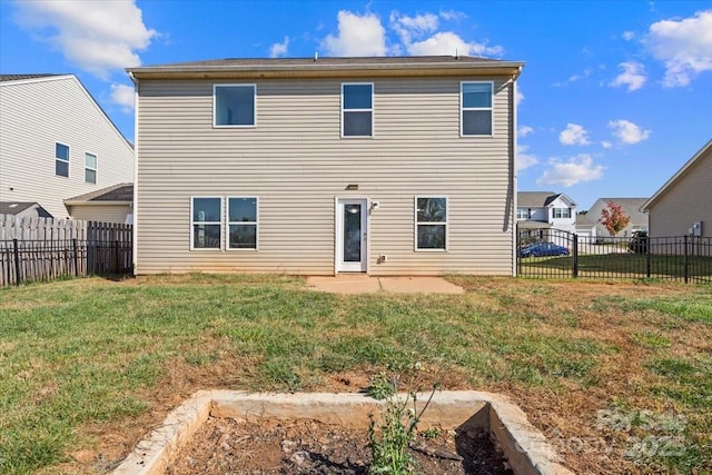 back of property with a yard and a patio area