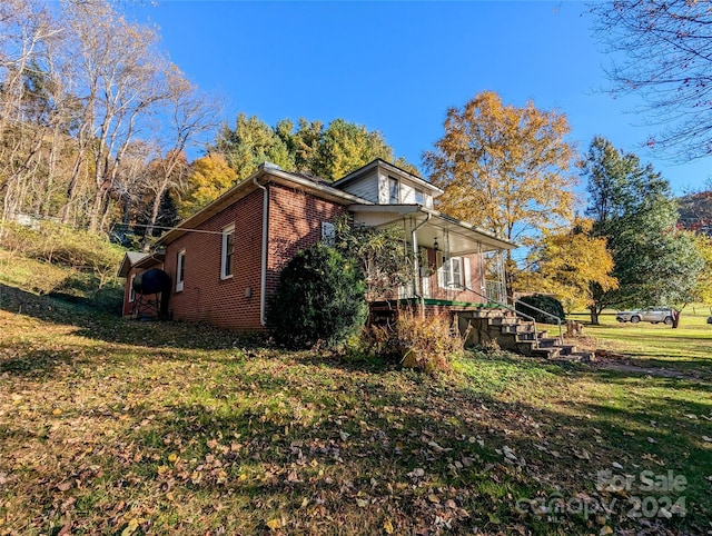 view of side of property with a yard