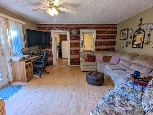 office area featuring brick wall and light wood-type flooring