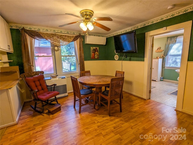 dining space featuring light hardwood / wood-style floors, plenty of natural light, a wall mounted air conditioner, and ceiling fan