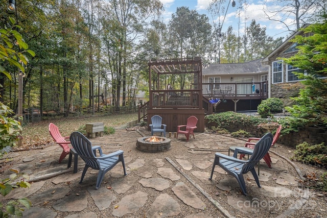 view of patio / terrace featuring a wooden deck and a fire pit