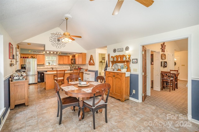 carpeted dining room featuring ceiling fan and vaulted ceiling