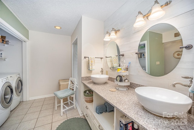 bathroom with washing machine and dryer, tile patterned floors, a textured ceiling, and vanity