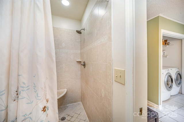 bathroom with washer and dryer, tile patterned floors, a textured ceiling, and a shower with shower curtain