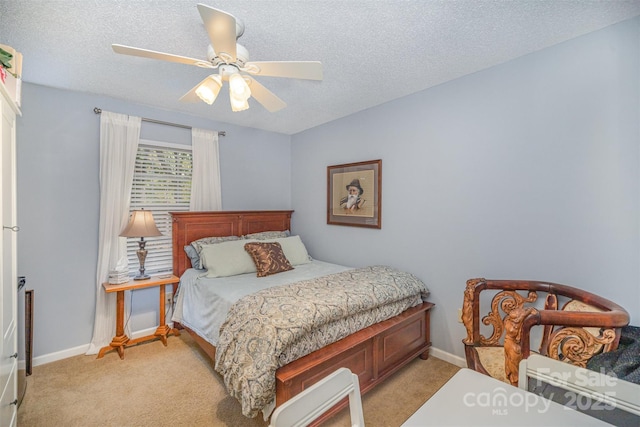 bedroom with light carpet, ceiling fan, and a textured ceiling